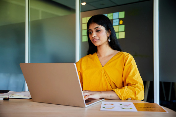 woman working on laptop in meeting room