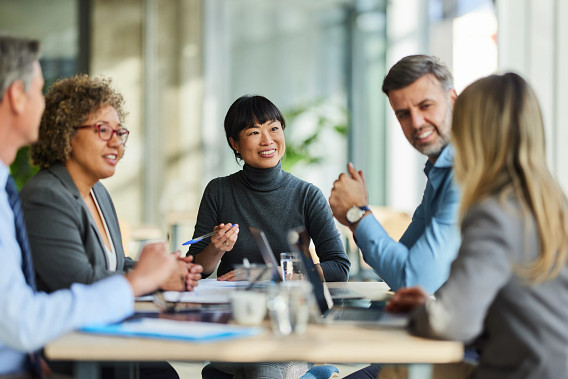 Team of people meeting around a desk