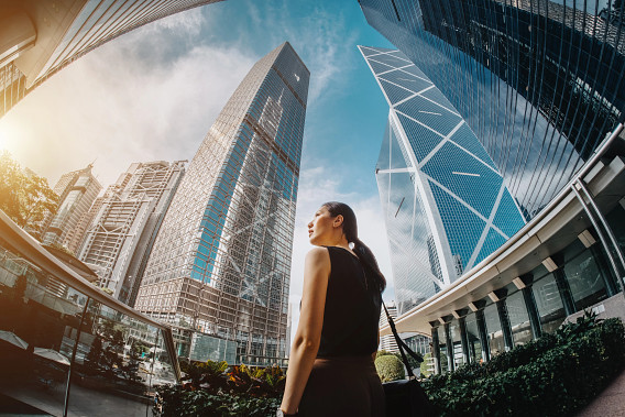 woman surrounded by business buildings